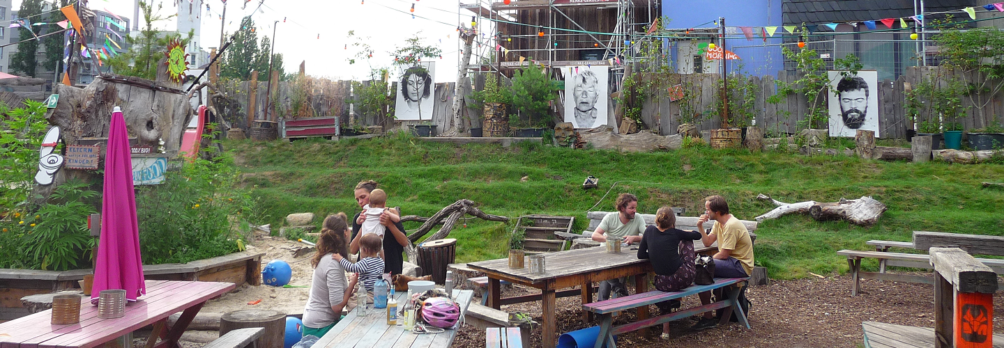 Menschengruppe im Gespräch auf Bänken am Holzmarkt in Berlin